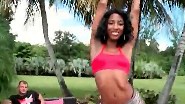 Flexible black chick in shiny booty shorts