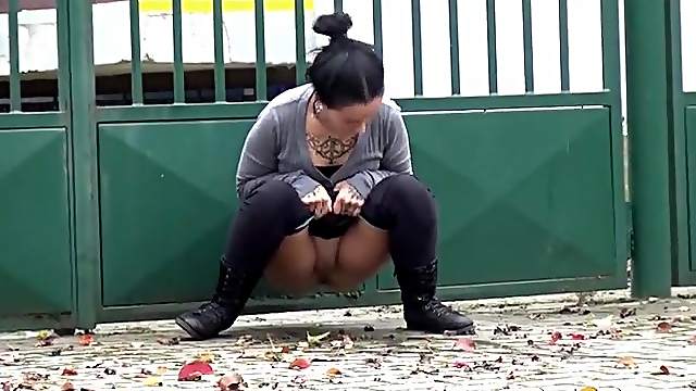 Tattooed girl pees in a driveway in public