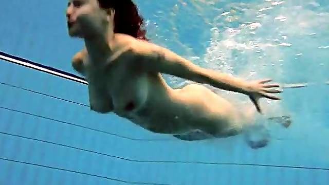Fit big breasted beauty swims in the pool