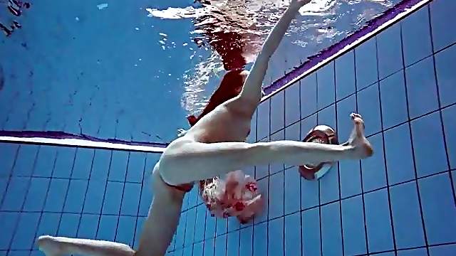 Slender teen goes for a swim in her pretty dress