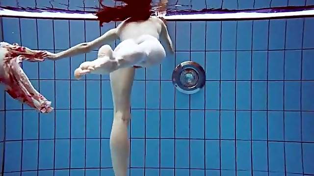 Slender teen goes for a swim in her pretty dress