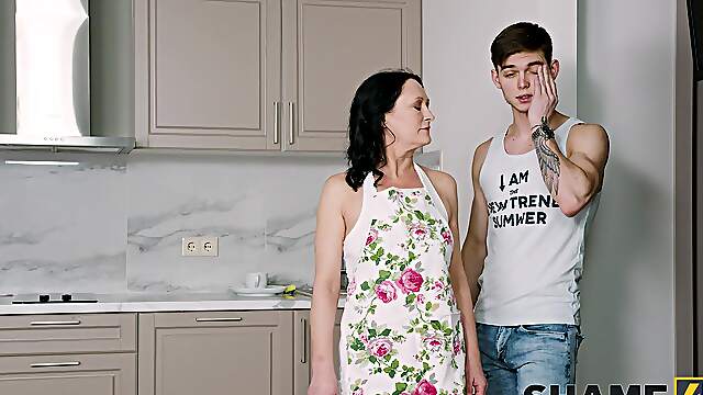 Aroused mature mom likes a bit of ass spanking when riding the young dick