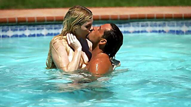 Two cute girls are having fun with boys in the pool, enjoying every moment.