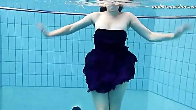 Redhead teen goes swimming in her prom dress