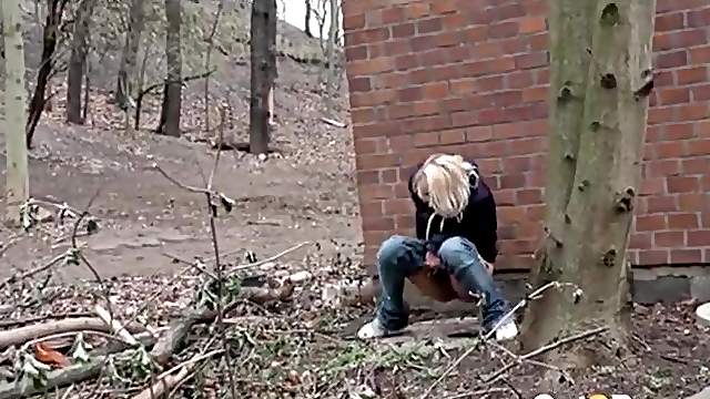 Teen lowers her jeans and pees outdoors