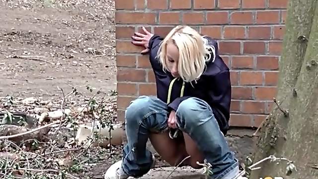 Teen lowers her jeans and pees outdoors