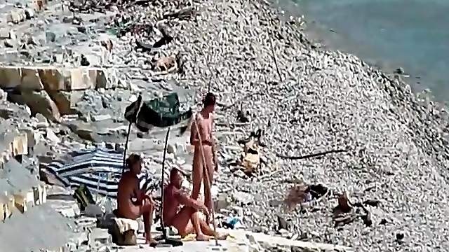 Two guys and a girl have sex on a day at the beach