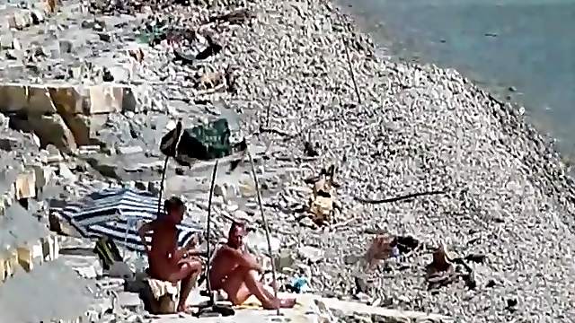 Two guys and a girl have sex on a day at the beach