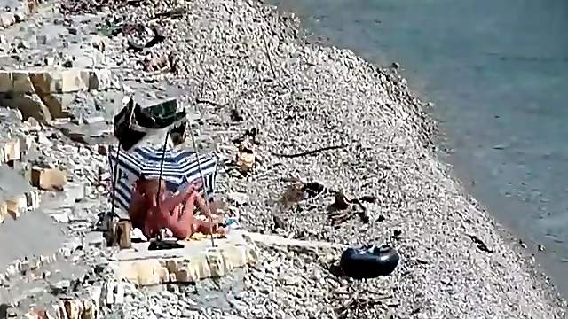 Two guys and a girl have sex on a day at the beach